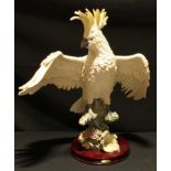 A large resin model of a cockatoo, The Juliana Collection, circular wooden base, 55cm