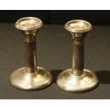 A pair of George V silver candlesticks, 10.5cm high, Chester 1914