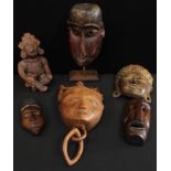 Tribal Art - a carved wooden mask; four others, Indonesian, African, etc; a South American
