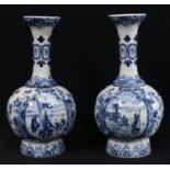A pair of blue and white Delft vases, decorated with panels of windmills and sailing boats, 30cm