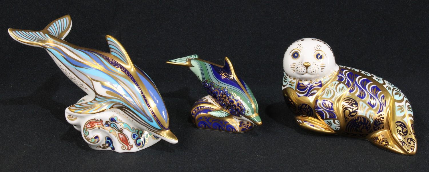 A Royal Crown Derby paperweight, Dolphin, gold stopper; others, Baby Bottlenose Dolphin, gold