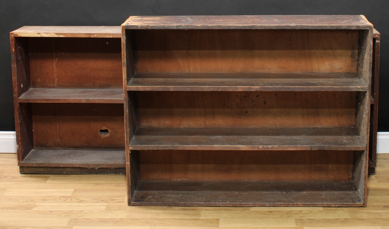 A mahogany shop fitting or bookcase, 74cm high, 182.5cm wide, 24cm deep; a set of pine shelves, 84cm