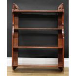 An Arts & Crafts mahogany wall-hanging open bookcase or wall shelf, shaped end supports, 86.5cm