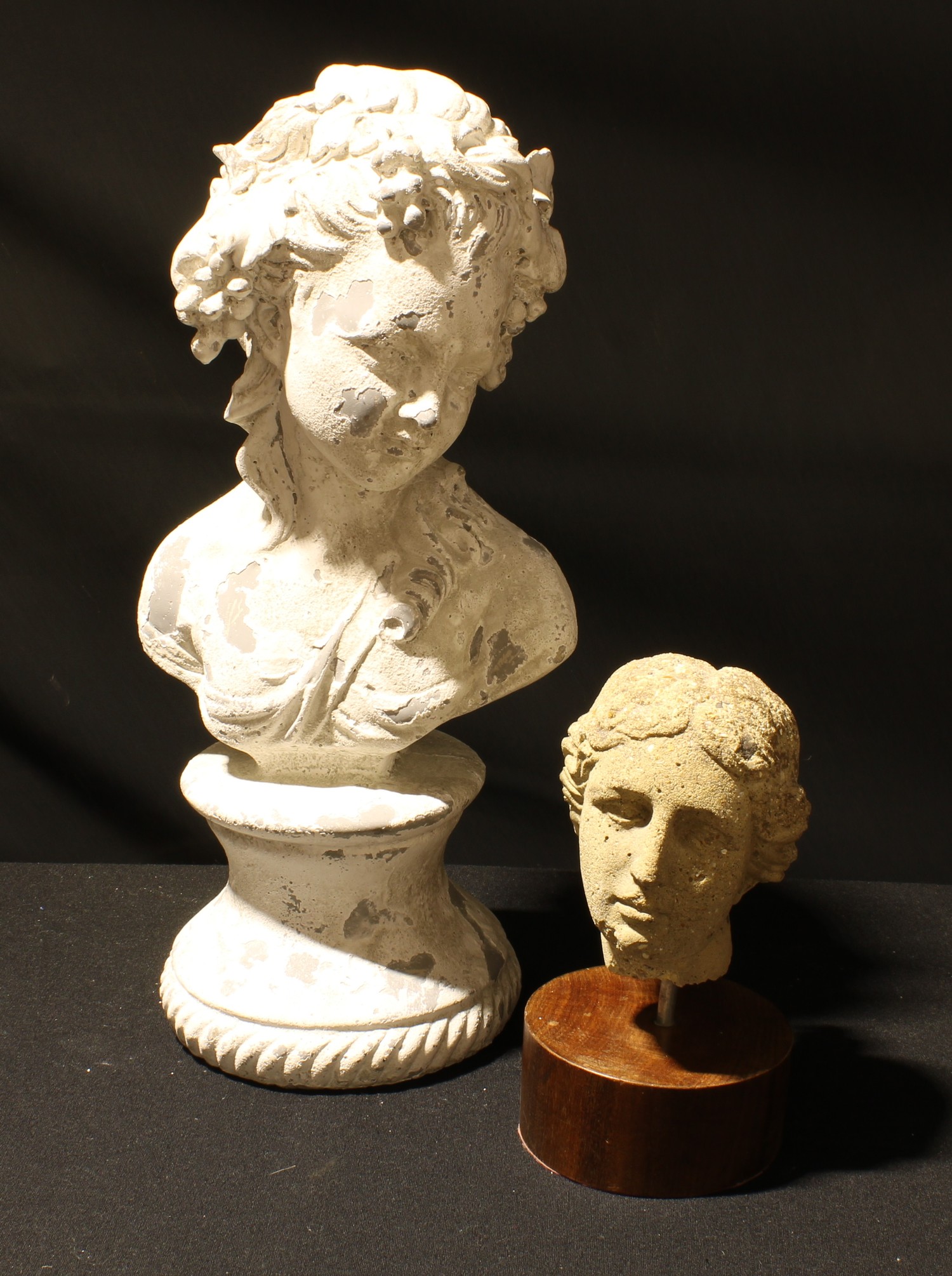 A classical antique style bust of a female, reconstituted stone, circular wooden base, 20cm; a