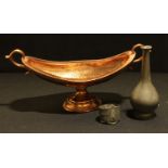 An Arts and Crafts design navette-shaped copper bowl, planished throughout, scroll-capped twin-