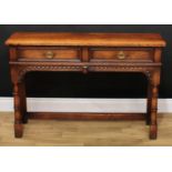 A Titchmarsh & Goodwin oak side table, slightly oversailing rectangular top above a pair of frieze