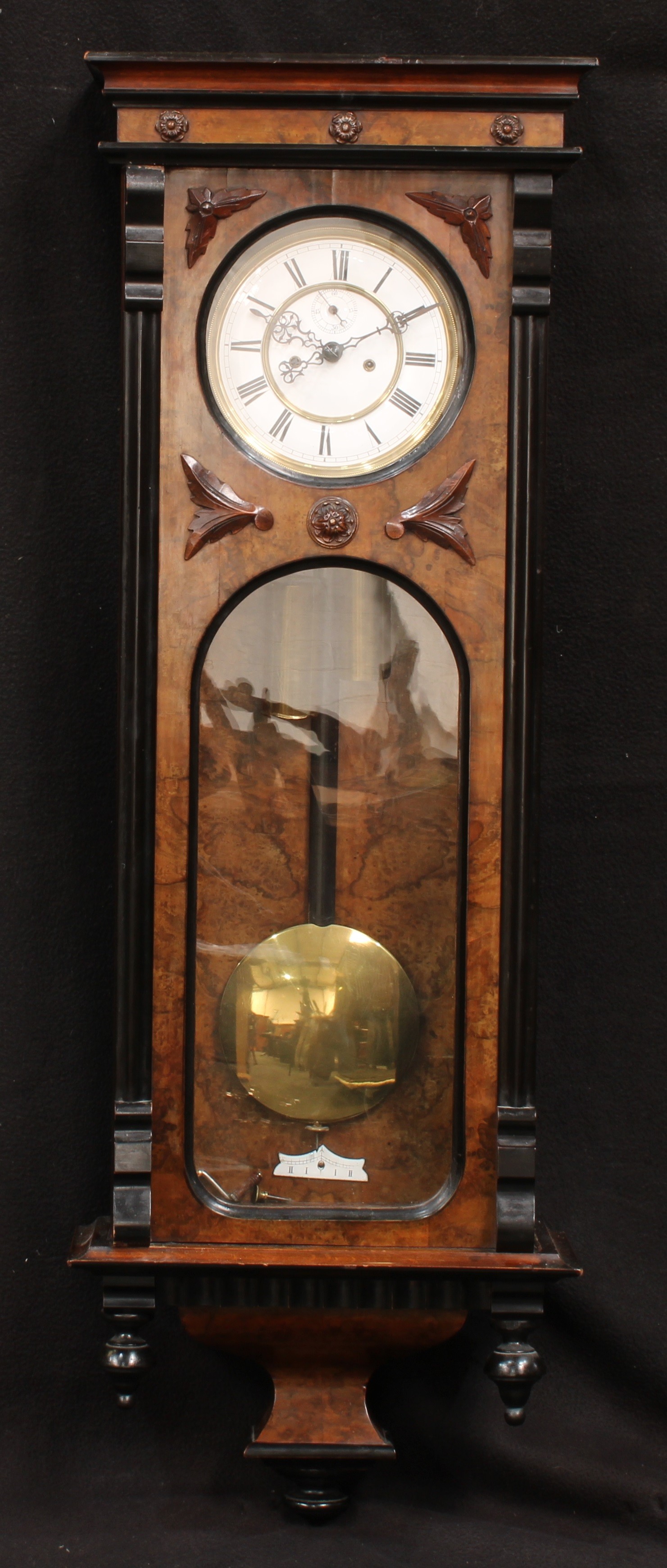 A late Victorian walnut and ebonised 'Vienna' wall clock, 109.5cm high, 36.5cm wide, 15.5cm deep