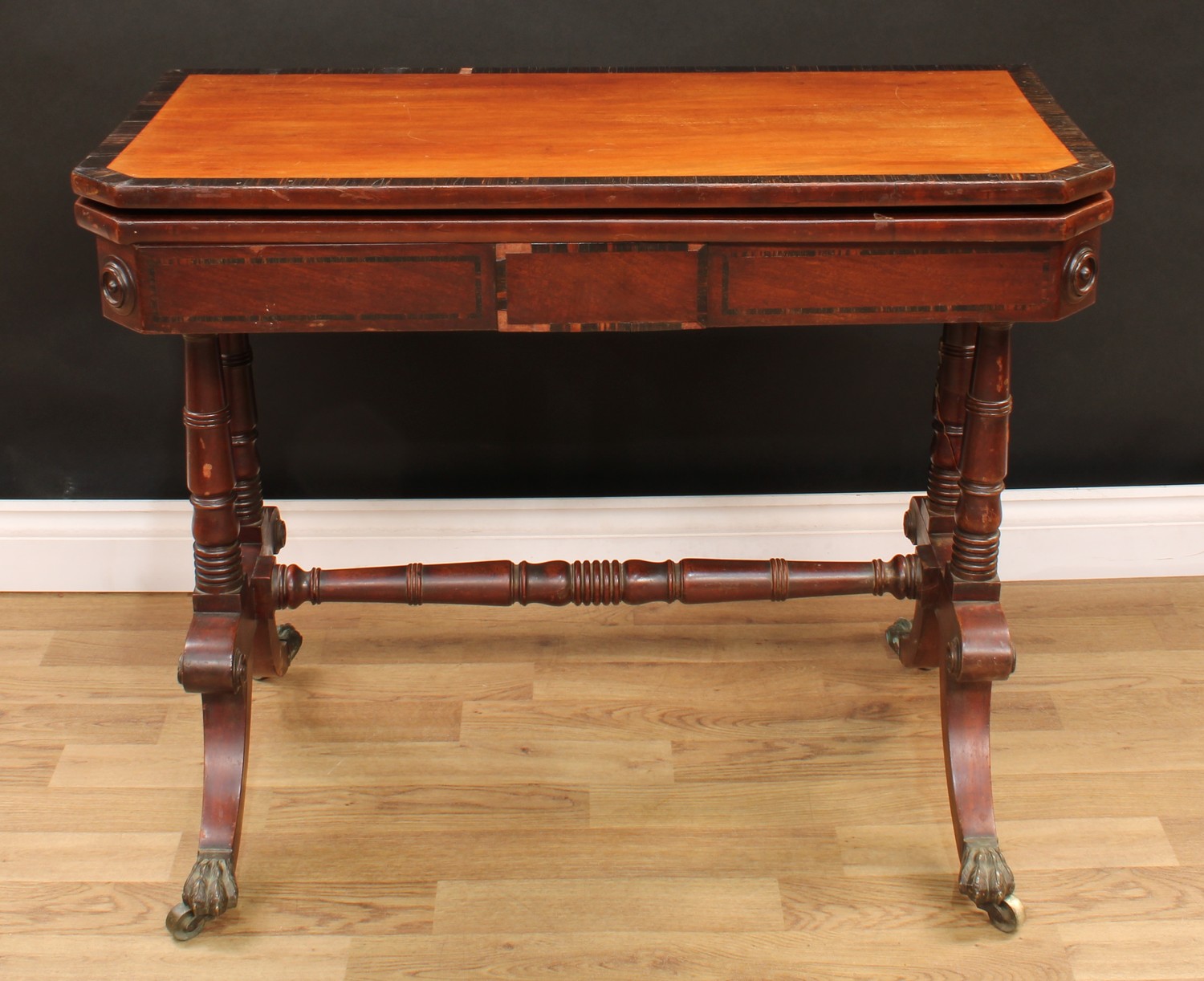 A William IV coromandel crossbanded mahogany card table, chamfered rectangular top enclosing a baize