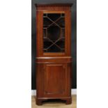 A George III Revival mahogany floor standing corner display cabinet, dentil cornice above a glazed