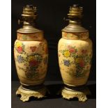 A pair of French oil lamps, the ceramic body decorated in the Japanese taste, later converted to