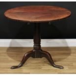 A George III oak tripod supper table, 67.5cm high, 82cm diameter
