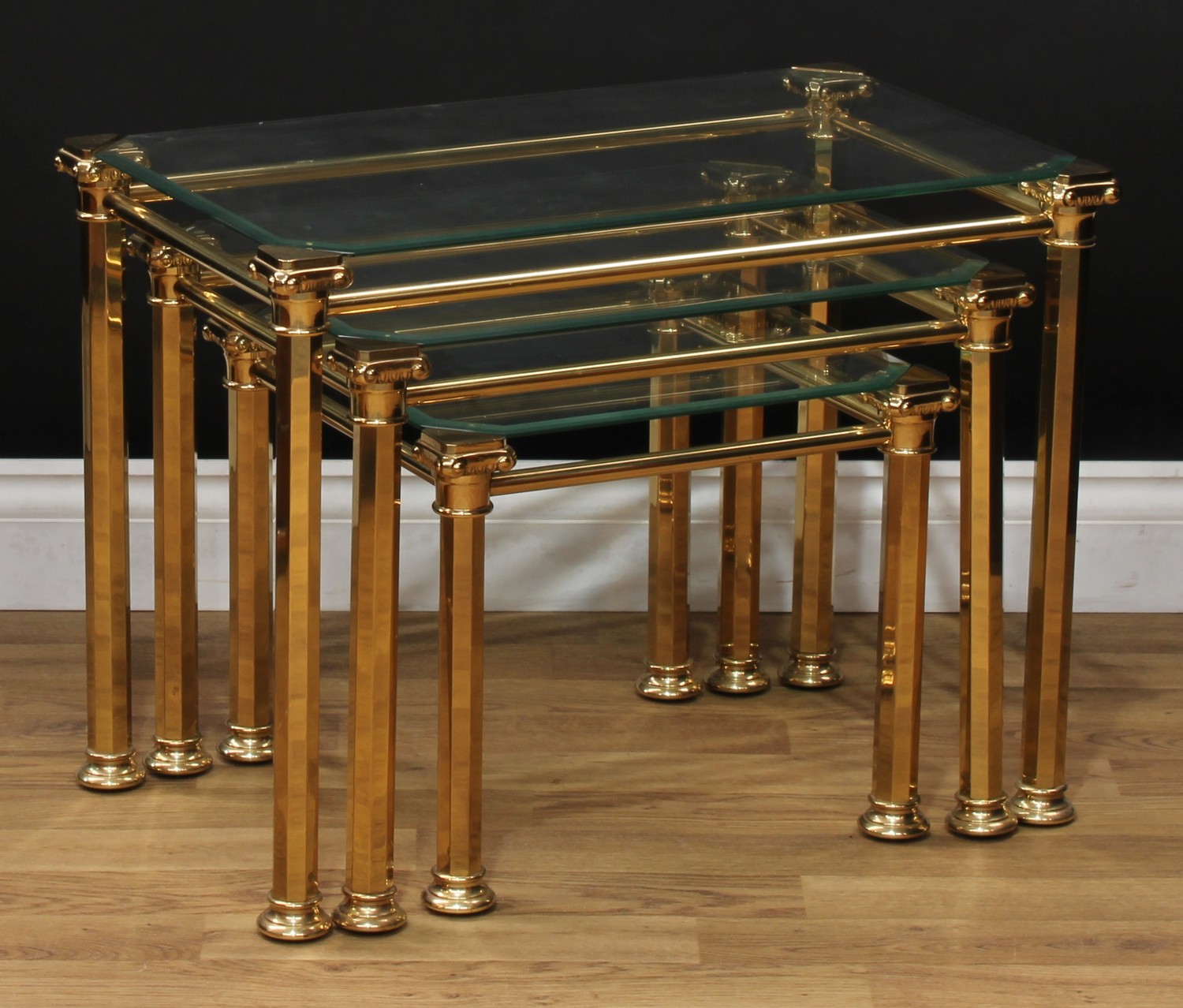 An Art Deco style brass and glass nest of three occasional tables, the largest 47.5cm high, 64cm