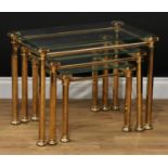 An Art Deco style brass and glass nest of three occasional tables, the largest 47.5cm high, 64cm