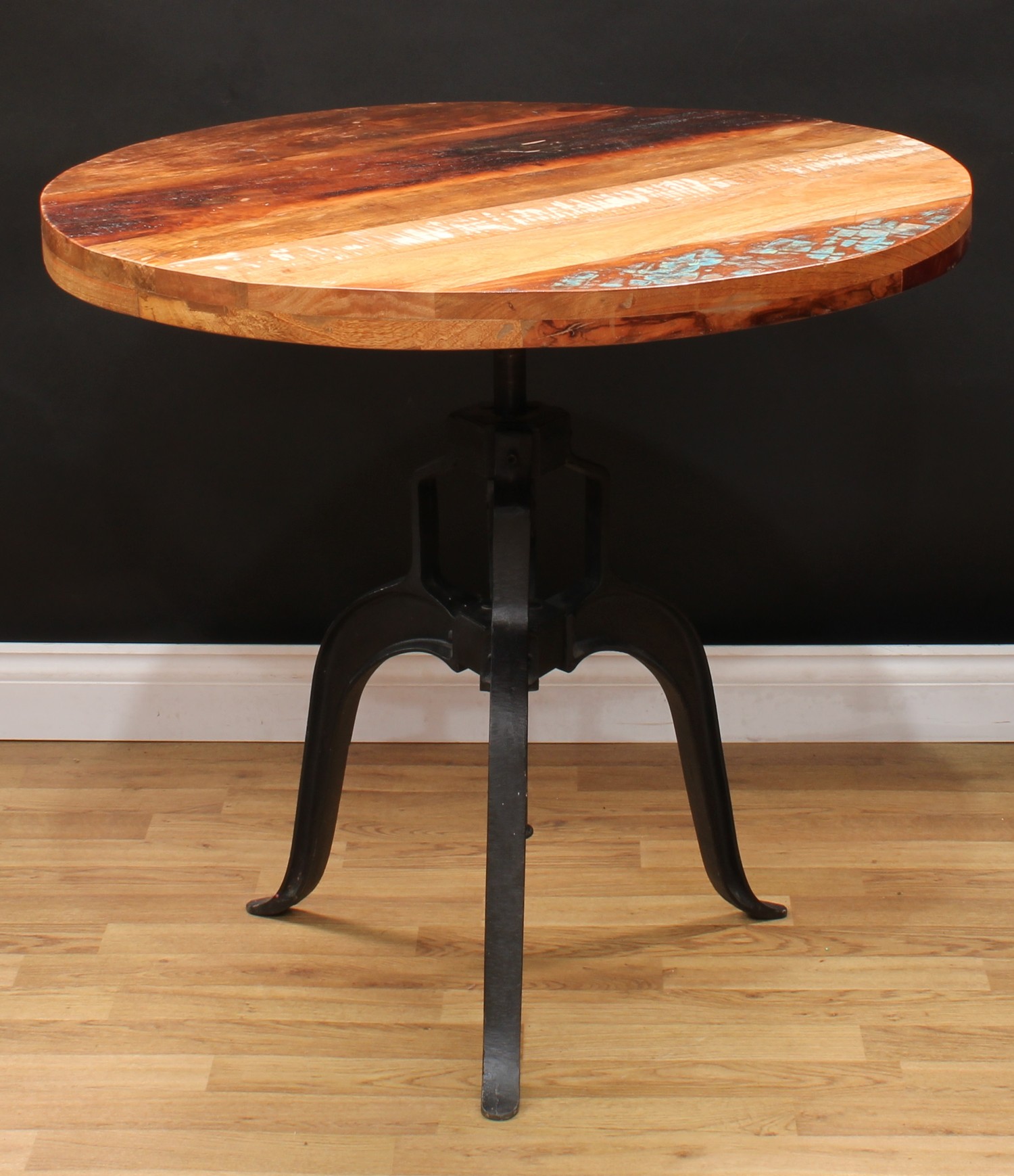 A contemporary cast metal frame circular table, interchangeable top, triform base, 81.5cm high, 90cm