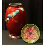 A Moorcroft circular pin tray, 12cm diameter; a Poole vase, 23cm (2)