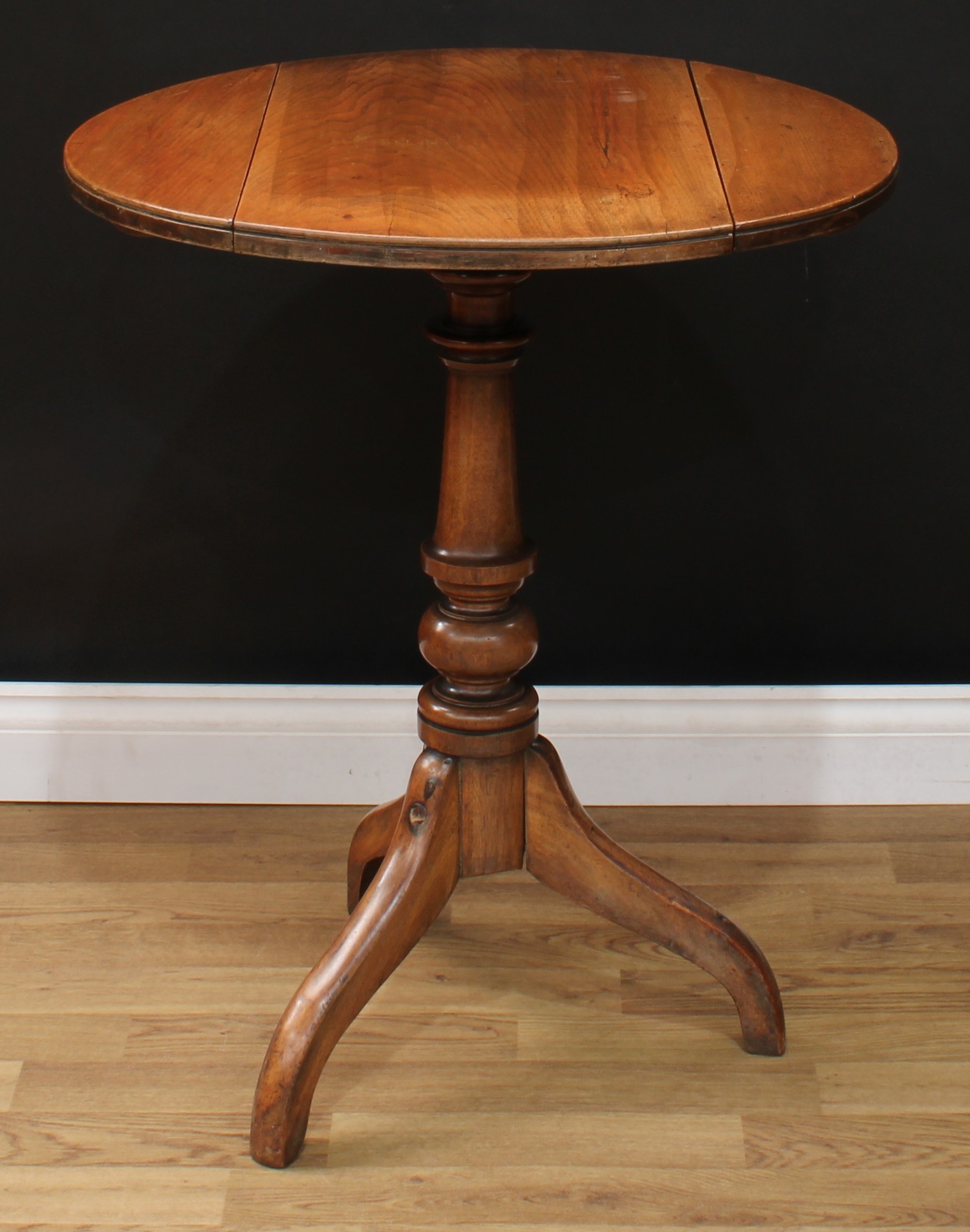 A George III style oak and mahogany tripod occasional table, circular top with fall leaves, turned