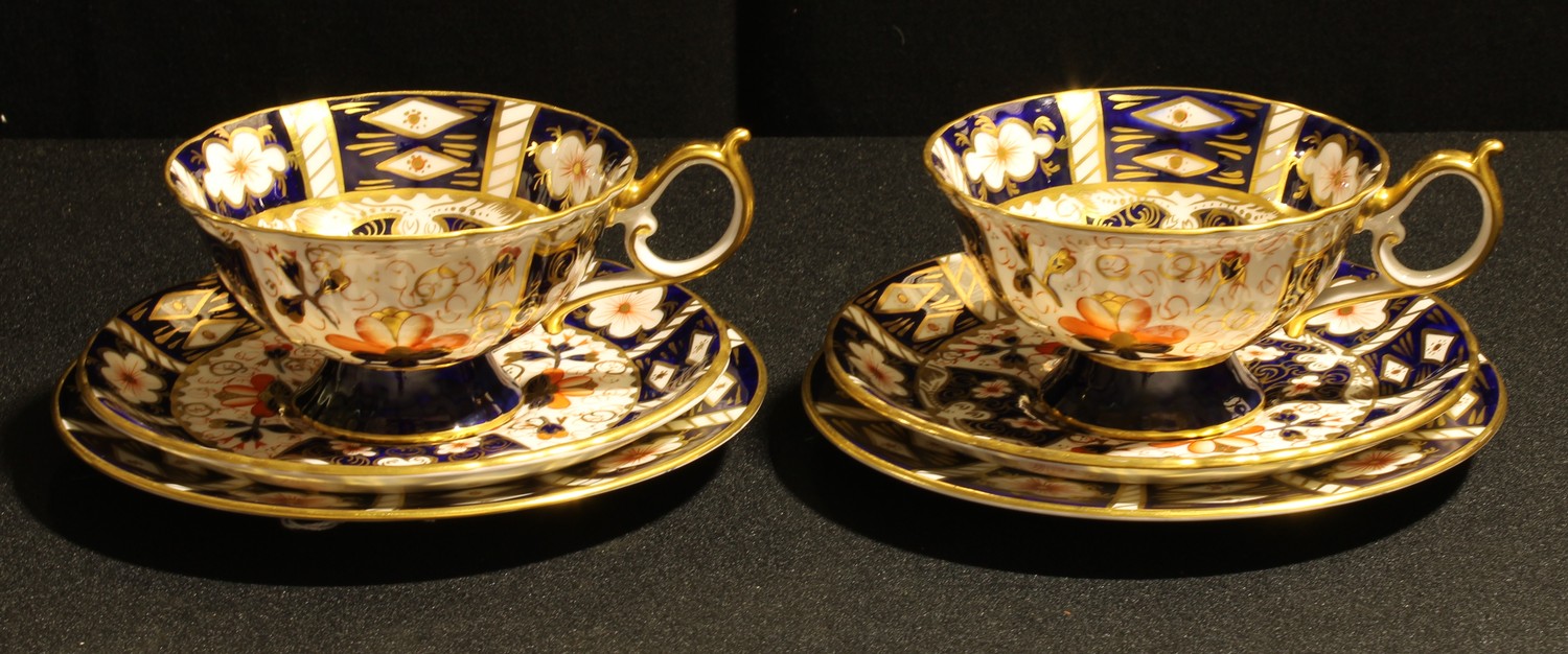 A pair of Royal Crown Derby 2451 Imari Elizabeth shape tea cups, saucers and tea plates, the tea