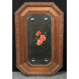 An oak framed wall mirror, painted with roses, bevelled edge with four roundels, 83cm x 52cm
