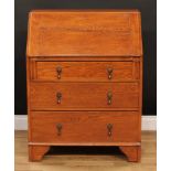 An early 20th century oak bureau, fall front enclosing a small drawer, pigeonholes and a small door,