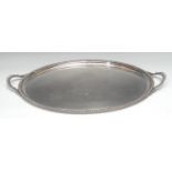 An E.P.N.S oval two-handled serving tray, plain field, gadrooned border, 65.5cm wide