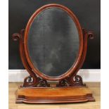 A large Victorian mahogany dressing mirror, oval plate, foliate scroll supports, stepped