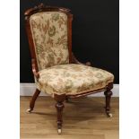 A Victorian walnut and mahogany drawing room chair, curved cresting rail carved with stylised