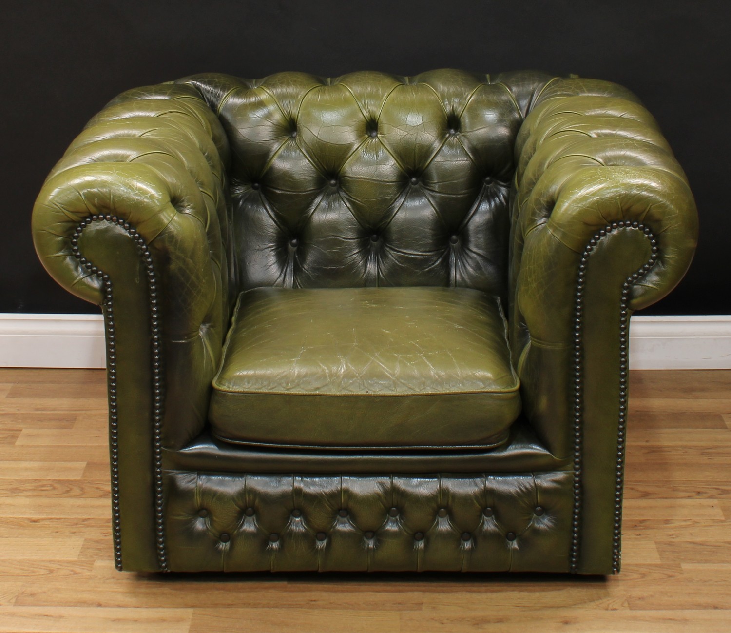 A Chesterfield design reception office armchair, stuffed-over deep-button upholstery, squab cushion,