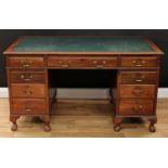 An early-mid 20th century mahogany twin pedestal desk, rectangular top with inset writing surface