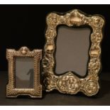 A silver Victorian style photograph frame, London 1982; another, London 1983 (2)