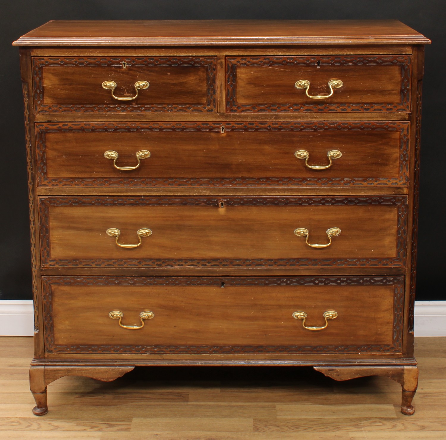 A Chippendale style chest, rectangular top with moulded edge above two short and three long