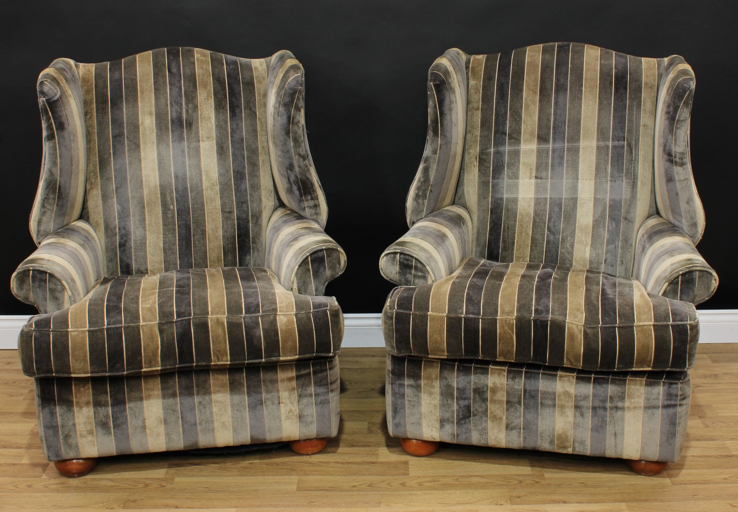 A pair of George III style wingback reception armchairs, 106cm high, 92cm wide, the seat 55cm wide