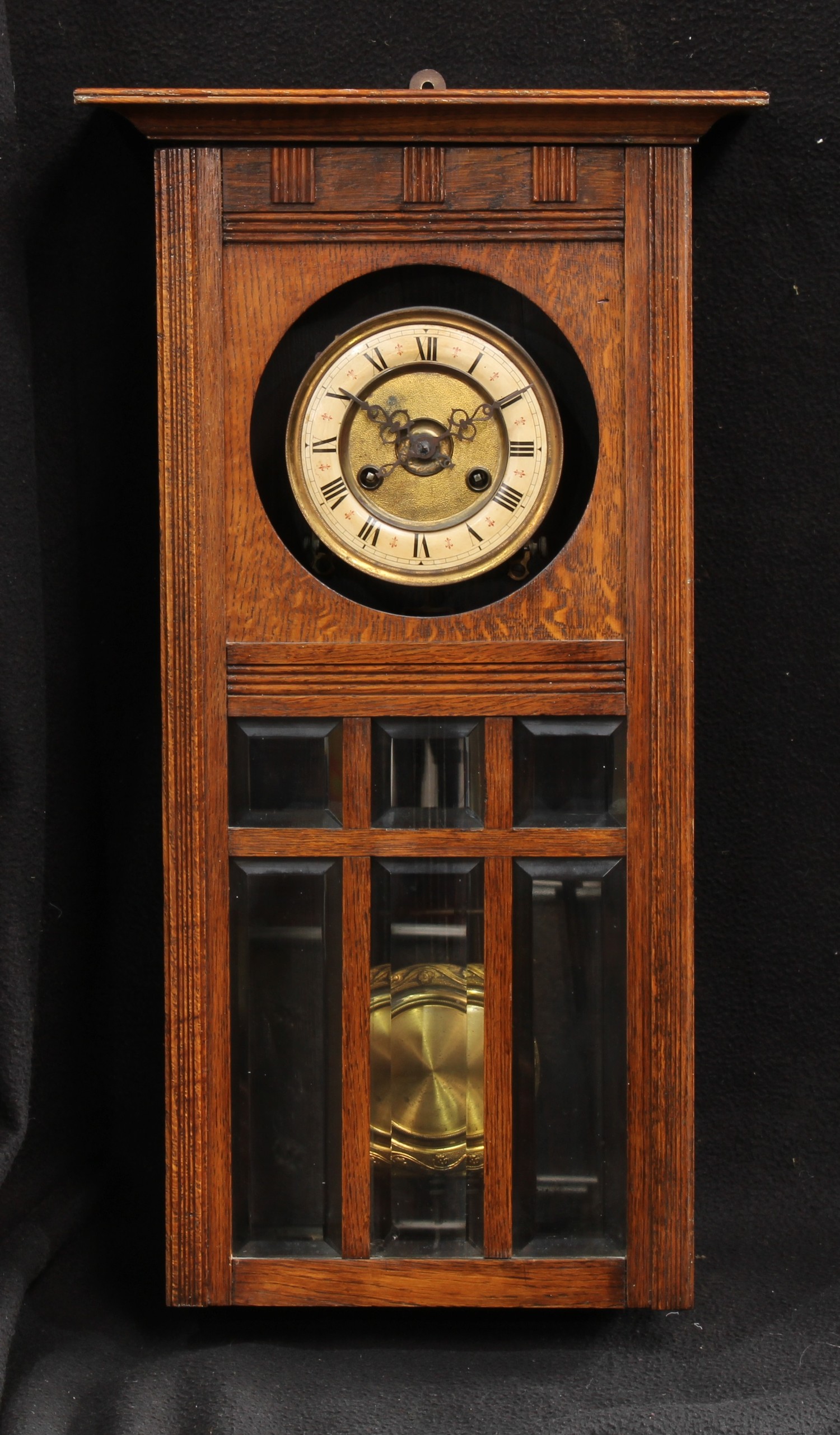 An early-mid 20th century oak wall clock, Roman numerals, 63.5cm high, 35cm wide, 19cm deep