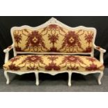 A Victorian painted three-seat salon sofa, shaped and carved cresting rail, stuffed over upholstery,