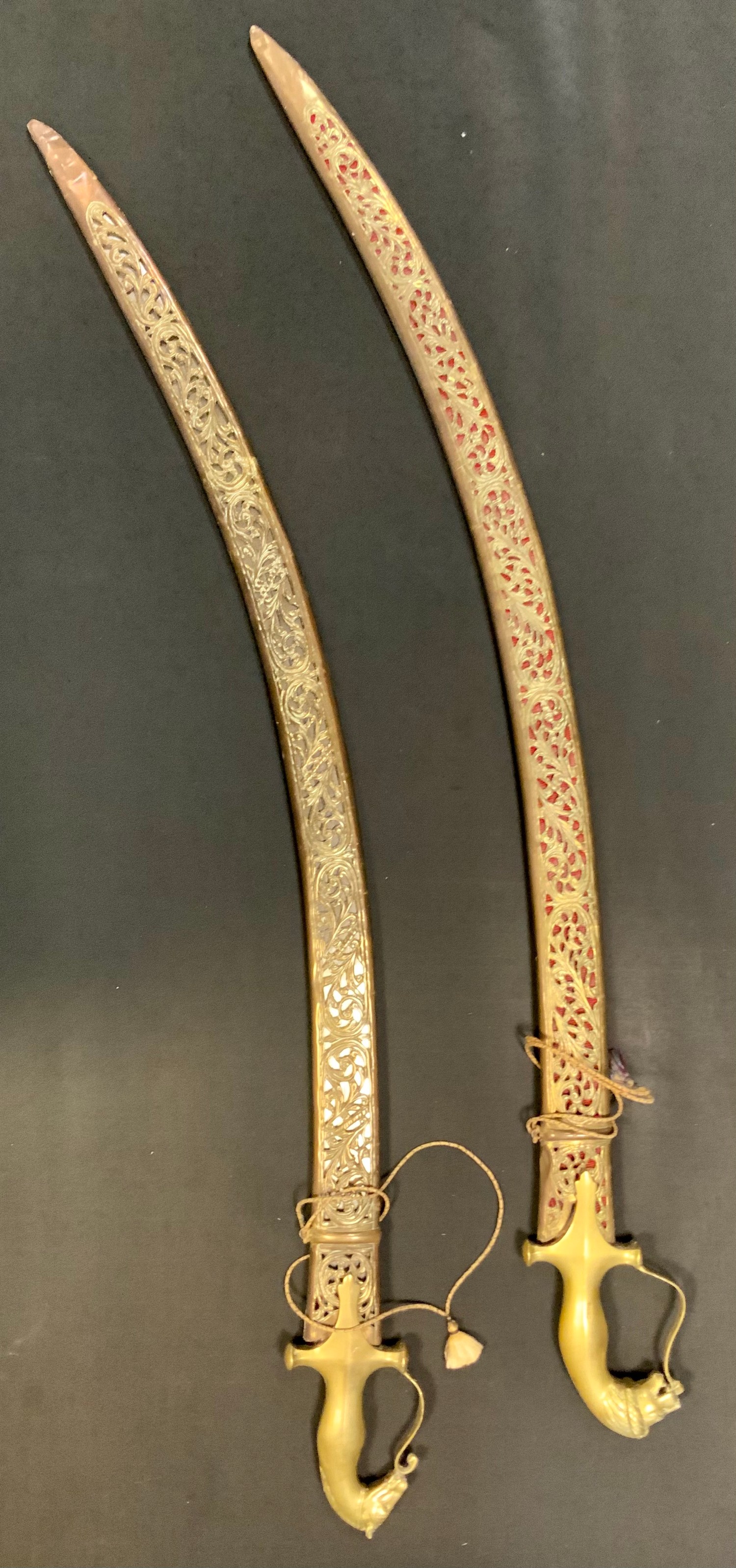 Two early 20th century Indian side arms, with horsehead hilts, pierced scabbards