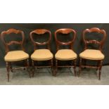 A pair of Victorian mahogany salon chairs, shaped backs, stuffed-over upholstery, turned legs;