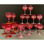 A set of eleven early 20th century ruby flashed wine glasses, cut with lozenges and stars, clear