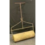 A stone and cast iron garden lawn roller, 133cm high, 93cm wide.