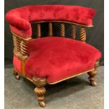 A late Victorian oak club chair, curved upholstered back with spindle gallery, stuffed-over seat,