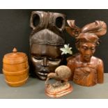 An African hardwood figure; a similar mask; a turned wooden tea caddy; a copper kiwi