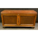 A 20th century oak blanket chest, hinged top above two panel front, 64cm high, 125cm wide, 51cm