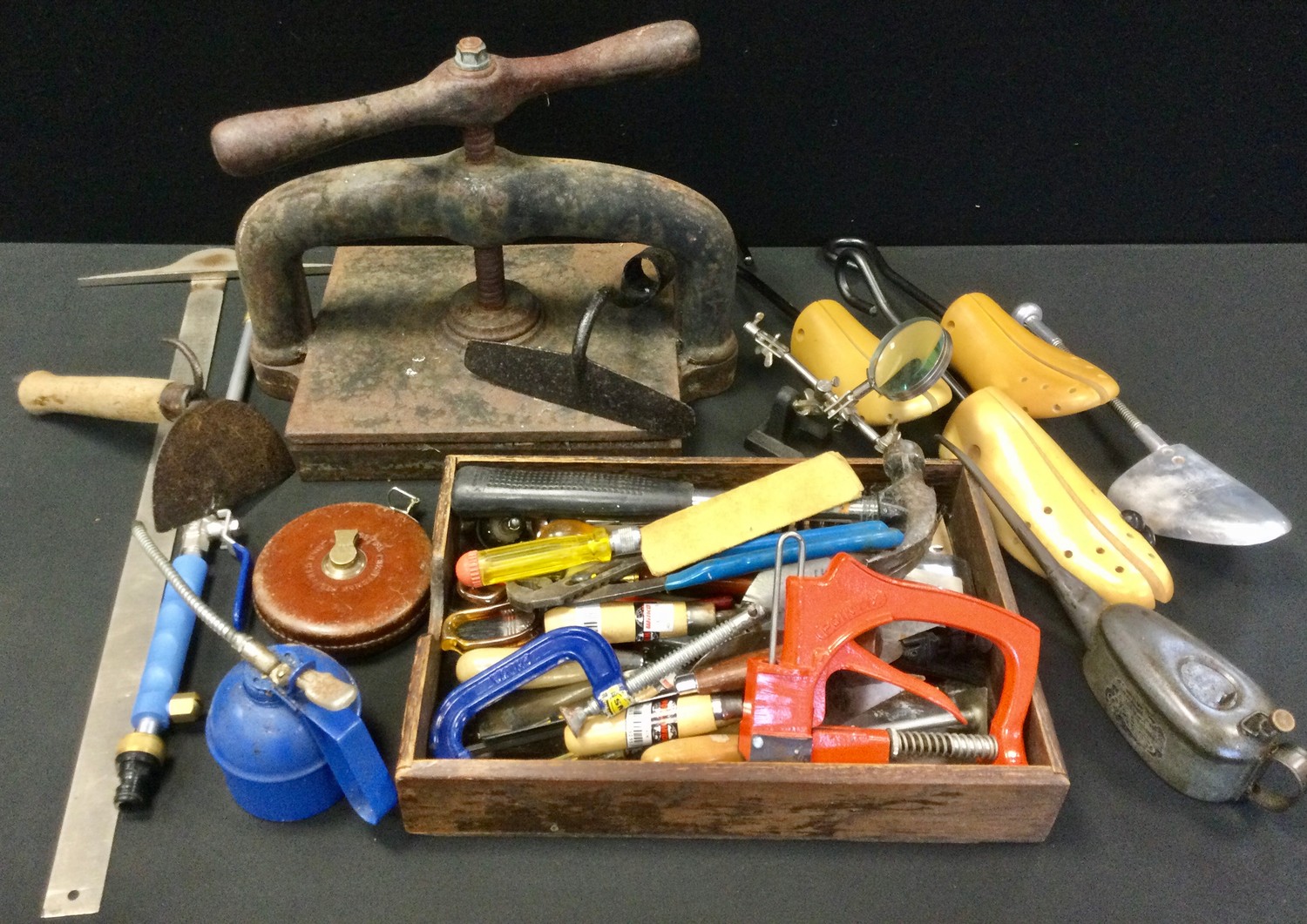 Tools - a Victorian cast iron book press; vintage oil can; another draper; clamps, hammers, glue