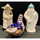 A Royal Worcester candle snuffer as a Nun; another, child in large winter coat, black, back stamp; a