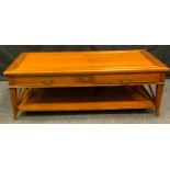 A contemporary coffee table, oversailing rectangular top above a pair of drawers, rectangular