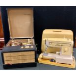 A Philco portable record player; a Singer Electric sewing machine (2)