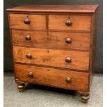 A Victorian mahogany chest of two short over three long graduated drawers, turned handles, shaped
