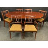 A reproduction twin pedestal extending dining table, oval top, paw feet, brass casters, one