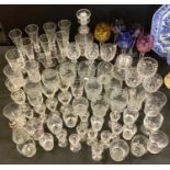 Glassware - five early 20th century coloured hock glasses; clear glass decanter; champagne flutes;