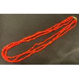 A three strand Coral bead necklace, 9ct gold clasp, 38cm long, 25.5g gross