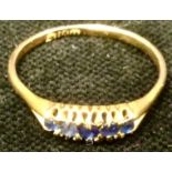 A sapphire quintet line ring, 18ct gold shank, 3g gross