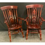 A pair of reproduction mahogany open arm chairs, outswept arms, saddle seats, 114cm high,(2)